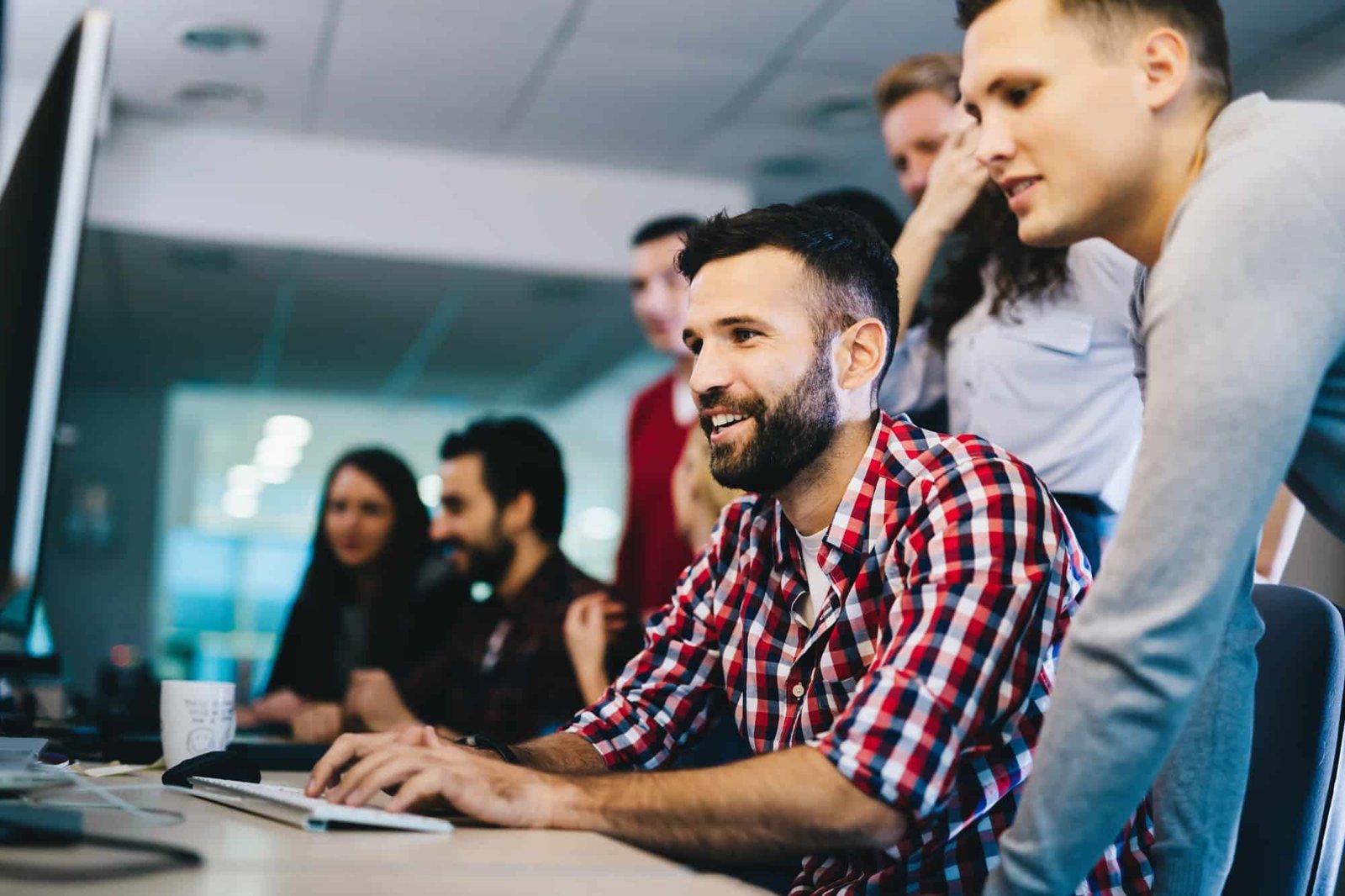 Programmers cooperating at information technology company
